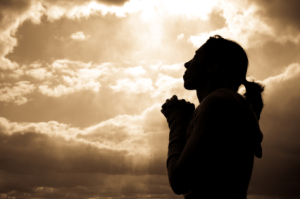 woman praying silhoutte